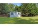 Serene backyard featuring a storage shed, privacy fence, and mature trees, offering a peaceful retreat at 55 Fleming Forest Dr, Youngsville, NC 27596