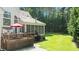 Spacious backyard with a wooden deck, screened-in porch, and lush lawn, perfect for outdoor entertaining at 55 Fleming Forest Dr, Youngsville, NC 27596