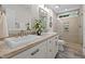 Bathroom featuring double sinks, granite countertops, and a glass-enclosed tiled shower at 55 Fleming Forest Dr, Youngsville, NC 27596
