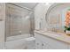 Bathroom with a glass enclosed shower, neutral tiles, and a decorative round mirror at 55 Fleming Forest Dr, Youngsville, NC 27596