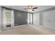 Neutral bedroom with carpet, ceiling fan, and natural light from two windows at 55 Fleming Forest Dr, Youngsville, NC 27596
