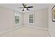 Bright bedroom with carpeted floors and natural light from two windows at 55 Fleming Forest Dr, Youngsville, NC 27596
