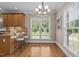 Bright and airy dining area featuring a window, breakfast bar, and a view of the lush backyard at 55 Fleming Forest Dr, Youngsville, NC 27596