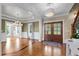 Grand entryway with hardwood floors, chandelier lighting, and double doors leading to formal rooms at 55 Fleming Forest Dr, Youngsville, NC 27596