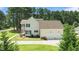 Charming two-story home featuring a two-car garage and a welcoming porch in a lush green setting at 55 Fleming Forest Dr, Youngsville, NC 27596