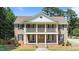 Exterior view of a stately brick home with a manicured lawn and welcoming front porch at 55 Fleming Forest Dr, Youngsville, NC 27596