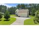 Aerial view of a traditional two-story home with a well-manicured lawn and an ample driveway at 55 Fleming Forest Dr, Youngsville, NC 27596