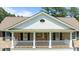 Charming front porch with white railings, columns, and double doors, enhancing curb appeal at 55 Fleming Forest Dr, Youngsville, NC 27596