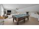 Spacious game room includes pool table, comfortable seating, and a wet bar for entertaining at 55 Fleming Forest Dr, Youngsville, NC 27596