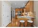 Open kitchen with bar seating, wood cabinets, stainless steel appliances, and convenient access to other rooms at 55 Fleming Forest Dr, Youngsville, NC 27596