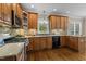 Well-equipped kitchen with custom cabinetry, stainless steel appliances, tile backsplash, and granite countertops at 55 Fleming Forest Dr, Youngsville, NC 27596