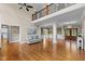 Open-concept living room showcasing hardwood floors, high ceilings, detailed trim, and a modern comfortable couch at 55 Fleming Forest Dr, Youngsville, NC 27596