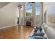 Bright living room featuring hardwood floors, a stone fireplace, large windows, and a comfortable couch at 55 Fleming Forest Dr, Youngsville, NC 27596