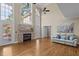 Inviting living room featuring a stone fireplace, hardwood floors, soaring ceilings, and large windows for natural light at 55 Fleming Forest Dr, Youngsville, NC 27596