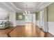 Spacious living room with hardwood floors, a seating area, and a large window offering ample natural light at 55 Fleming Forest Dr, Youngsville, NC 27596