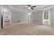Spacious bedroom with neutral carpeting, tray ceilings, and views to the entry room at 55 Fleming Forest Dr, Youngsville, NC 27596