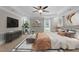 Bright main bedroom features tray ceiling, fan, and decoratively styled shelves for an inviting space at 55 Fleming Forest Dr, Youngsville, NC 27596