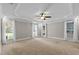 A generously sized bedroom features a tray ceiling, neutral carpet, and lots of windows for natural light at 55 Fleming Forest Dr, Youngsville, NC 27596