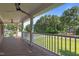 Inviting porch with wooden deck and columns, offering scenic views of the lush yard and trees at 55 Fleming Forest Dr, Youngsville, NC 27596