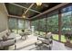 Relaxing sunroom with multiple windows, neutral furniture, ceiling fans, and a view of the backyard at 55 Fleming Forest Dr, Youngsville, NC 27596