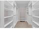 Spacious walk-in closet with custom shelving, rods, and a convenient ladder for upper storage at 55 Fleming Forest Dr, Youngsville, NC 27596