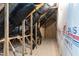 An unfinished attic showing exposed beams, insulation, and construction materials at 55 Shoreline Dr, Lillington, NC 27546