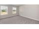 Bright bedroom with natural light from two windows, soft carpet, fresh paint, and a view of the outdoors at 55 Shoreline Dr, Lillington, NC 27546