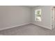 Inviting bedroom with soft carpeting, a window for natural light, neutral wall color, and white trim accents at 55 Shoreline Dr, Lillington, NC 27546