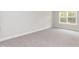 Comfortable bedroom featuring soft carpeting, a sunlit window, neutral wall color, and a calming atmosphere at 55 Shoreline Dr, Lillington, NC 27546