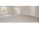 Expansive bedroom featuring plush carpeting, plenty of natural light from two windows, and a welcoming doorway at 55 Shoreline Dr, Lillington, NC 27546
