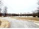 View of the Cape Fear River along paved trail with trees on the horizon at 55 Shoreline Dr, Lillington, NC 27546