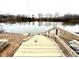 Water view from wooden dock surrounded by trees and nature on an overcast day at 55 Shoreline Dr, Lillington, NC 27546