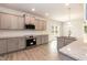 Well-lit kitchen with gray cabinets, stainless steel appliances, granite countertops, and laminate floors at 55 Shoreline Dr, Lillington, NC 27546