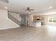 Open living room with an adjacent kitchen and staircase at 55 Shoreline Dr, Lillington, NC 27546