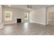 Cozy living room with fireplace, windows, and gray wood floors at 55 Shoreline Dr, Lillington, NC 27546