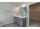 Double vanity in the main bathroom with gray cabinets and tile floors at 55 Shoreline Dr, Lillington, NC 27546