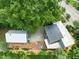 Aerial view showcasing the home's deck, manicured landscaping, lush greenery, and ample parking at 701 Holloway St, Durham, NC 27701