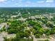 Picturesque aerial view showcases a neighborhood surrounded by lush greenery and mature trees under a partly cloudy sky at 701 Holloway St, Durham, NC 27701