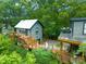 Aerial shot of a home featuring multiple outdoor decks surrounded by lush greenery and mature trees at 701 Holloway St, Durham, NC 27701
