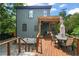 Backyard view of a house showcasing a wooden deck with outdoor seating and lush greenery, ideal for relaxation at 701 Holloway St, Durham, NC 27701