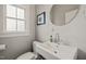 Elegant bathroom with a pedestal sink, stylish fixtures, and a well-lit ambiance at 701 Holloway St, Durham, NC 27701