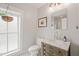 Charming bathroom features a rustic vanity with a marble countertop, offering a blend of style and comfort at 701 Holloway St, Durham, NC 27701