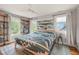 Comfortable bedroom with large windows, natural light, and built-in shelving, offering a serene retreat at 701 Holloway St, Durham, NC 27701