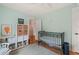 Cozy Bedroom featuring a crib, shelving, and charming decor, perfect for a retreat at 701 Holloway St, Durham, NC 27701