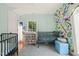 Bright Bedroom with colorful wall art, crib, changing table, and natural light, creating a playful space at 701 Holloway St, Durham, NC 27701