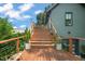Inviting outdoor space with a wood deck, stylish railing, and charming plant decor leading to the main house entrance at 701 Holloway St, Durham, NC 27701