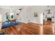 Open concept dining area with hardwood floors, white walls, and a modern wood table and chairs at 701 Holloway St, Durham, NC 27701