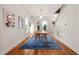 Bright dining room features hardwood floors, white walls and a modern wooden table under pendant lighting at 701 Holloway St, Durham, NC 27701