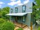 Charming home with covered front porch, dormer windows, wood trim, and verdant landscaping at 701 Holloway St, Durham, NC 27701