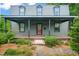 Charming home with covered front porch and dormer windows, framed by lush landscaping at 701 Holloway St, Durham, NC 27701